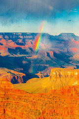 Panoramisch beeld van de kleurrijke regenboog over de Grand Canyon in het Grand Canyon National Park vanaf het deel van de zuidelijke rand, Arizona, VS, zonsondergang op een zonnige bewolkte dag met blauwe lucht