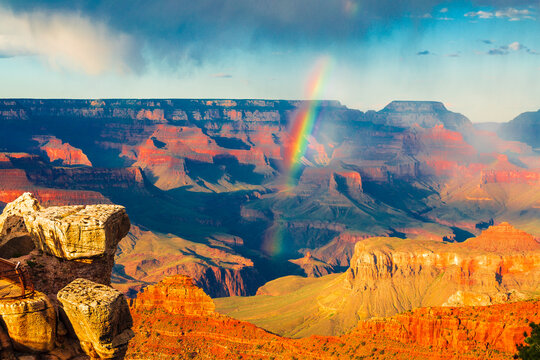 Panoramic image of the colorful rainbow over the Grand Canyon in Grand Canyon National Park from the south rim part,Arizona,USA, sunset on a sunny cloudy day with blue sky