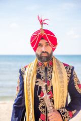 Sikh male model in traditional wedding attire preparing for ceremony