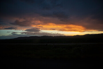 Fototapeta na wymiar sunset over the mountains near dirt road