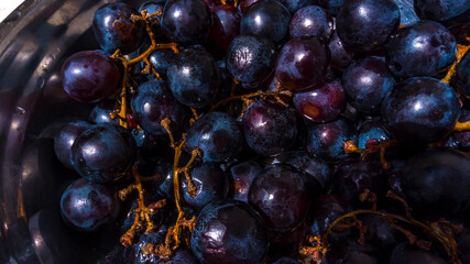 washing grapes in an aluminum dish