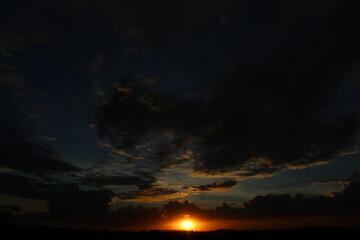 Fototapeta premium Dark clouds at sunset