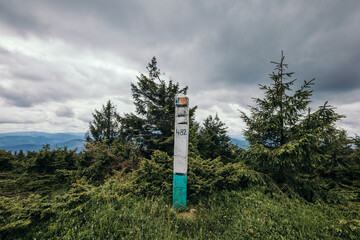 A sign on a grassy hill