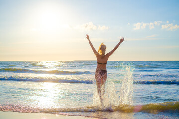 Happy woman in waving sea