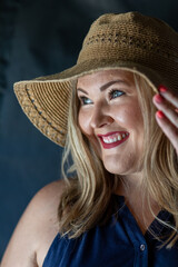 Woman wearing a hat having fun on a summer day in the sunlight