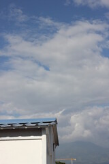 blue sky with shaped clouds and a blue roof in palmira