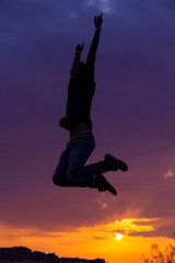 Young man, businessman jump happy sunset