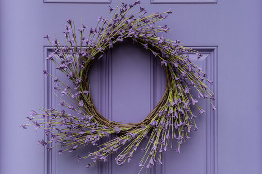 Photograph Of A Seasonal Summer Wreath On A Lavender Colored Door