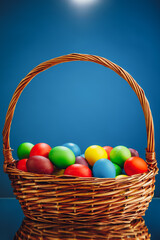 Easter color eggs in festive gift basket, blue background