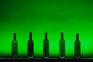 abstract empty wine bottles with green led illumination