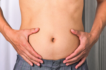 Skinny man with belly fat pulled have pulled their abdominal muscle