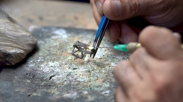 Craftsman diamond welding gold ring.Diamond ring jewelery product. Close up craftsman workshop macro shooting. hand made jewelery making.