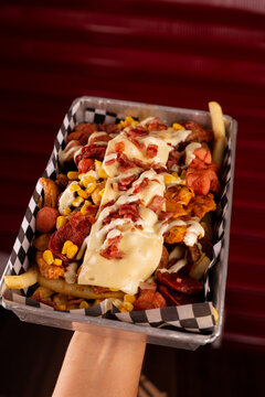 delicious crazy potatoes from colombia. french fries, sausage, meat, chicken and cheese(papas locas)