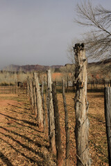old fence with shadows on ground in rural desert countryside