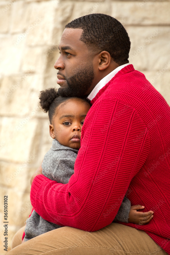 Wall mural African American father holding his daughter.