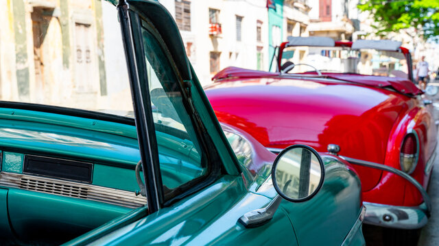 Vintage classic American oldtimer car in the old town of Havana, Cuba. Colorful scene of the vibrant streets of the famous capital.