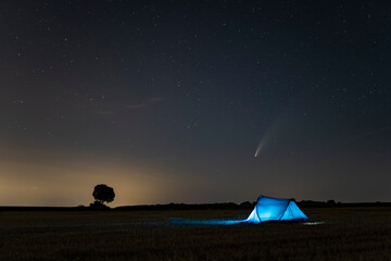 C / 2020 F3 comet (NEOWISE) in the evening sky. Camping under the starry sky, where there is a...