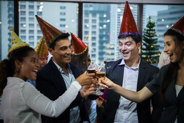 Business people or team or friend or colleagues are drinking together with glass of champagne or alcohol in party after work, happy new year celebration fun in office