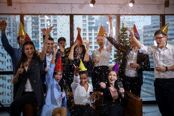 Business people or team or friend or colleagues are drinking together with glass of champagne or alcohol in party after work, happy new year celebration fun in office