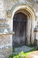 Fototapeta na wymiar weathered wooden door in stone archway