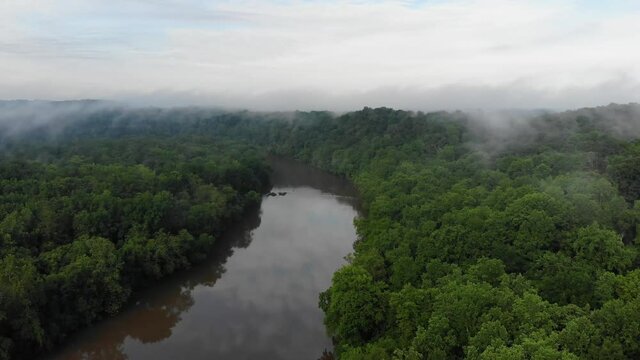 Drone footage of a river on a foggy day.