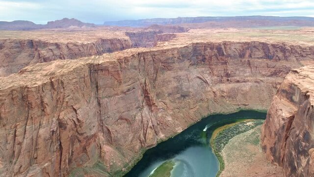 4K aerial Horseshoe bend park, Page, Arizona, USA. Drone robot exploring the surface of deep canyon on the red planet Mars with water on surface. Space tourism. Wild nature. Galaxy travel