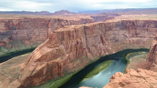 4K aerial world famous tourist attraction - Horseshoe bend canyon, Arizona. Cinematic American Wild West wilderness nature. Aerial red cliffs over Colorado river. USA travel and road trip footage