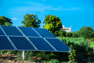 Small Solar Panel Installed In Agriculture Field With Blue Sky, Green environment.