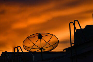 satellite dish on sunset sky