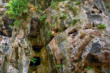 Textured rock, close-up. Rock with depressions and depressions. Upper Duden waterfall, Turkey, Antalya