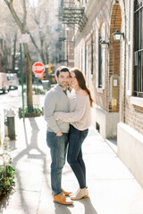 A happy young couple having a romantic moment in an urban setting in West Village in NYC