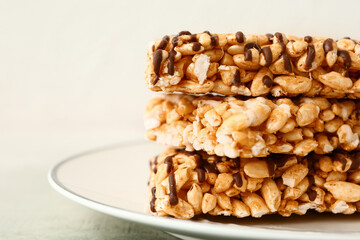Plate with crispy rice bars on table, closeup