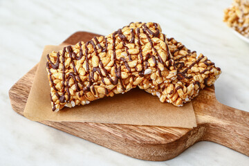 Board with crispy rice bars on table