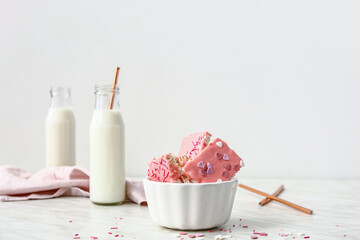 Bowl with crispy rice bars and milk on table