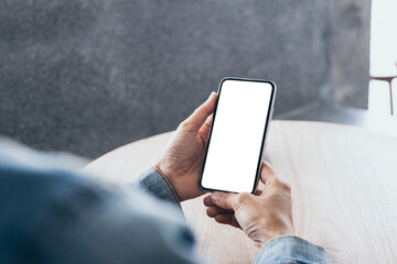 cell phone mockup image blank white screen.woman hand holding texting using mobile on desk at coffee shop.background empty space for advertise.work people contact marketing business,technology