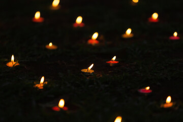 Burning candle on the background in darkness, closeup with space for text.