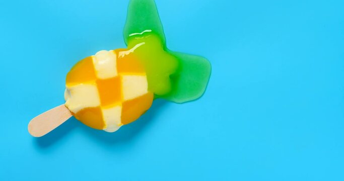 top view pineapple shape popsicle melting timelapse on blue background 