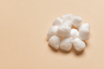 Cotton balls on color background