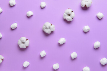 Cotton balls with flowers on color background