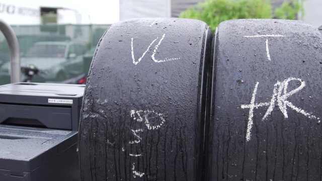 Race tires stacked on trolley, formula 1, racing slicks, slick tyre