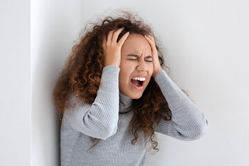 Stressed African-American woman at home. Stop racism