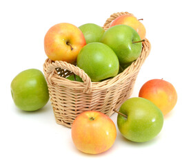 Red and green apples in basket on white background