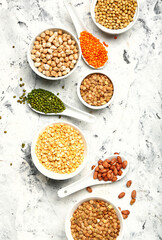 Different raw legumes on white background