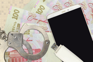 100 Ukrainian hryvnias bills and smartphone with police handcuffs. Concept of hackers phishing...