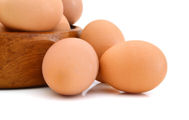 Raw eggs isolated in wooden bowl white background