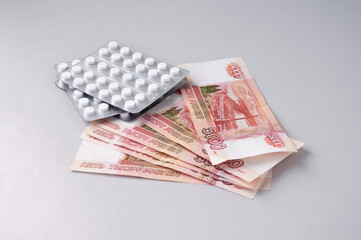 Five-thousand-dollar bills and medicines, a concept of medical expenses