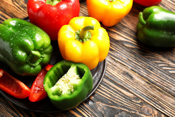 Fresh bell peppers on wooden background