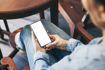 cell phone mockup image blank white screen.woman hand holding texting using mobile on desk at coffee shop.background empty space for advertise.work people contact marketing business,technology