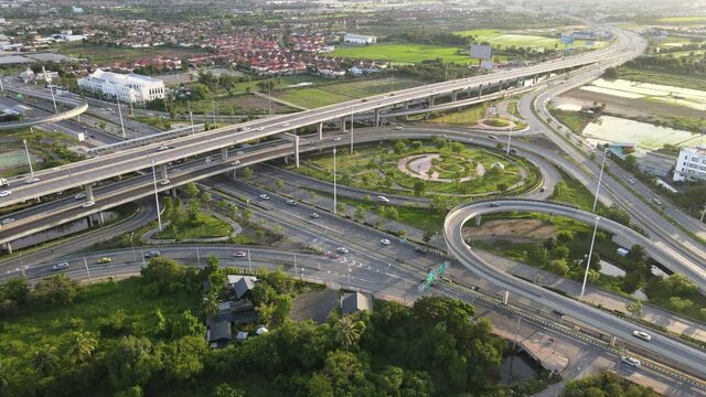 4K. Aerial view of infinity highway road interchange with busy urban traffic speeding on the road. Junction network of transportation in Bangkok, Thailand. taken by drone