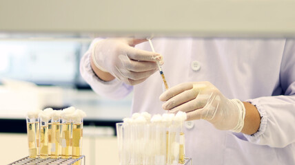 Scientist transfer sample using syringe, Most Probable number (MPN) technique for counting the...
